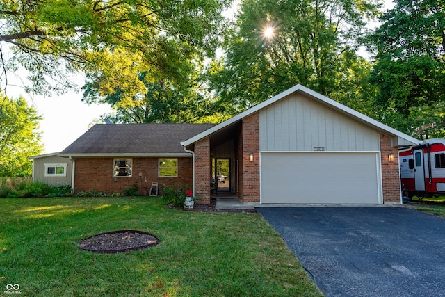 ranch-style home with a garage and a front lawn