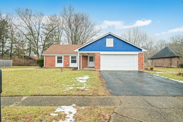 view of front of home with a garage, aphalt driveway, a front lawn, and brick siding