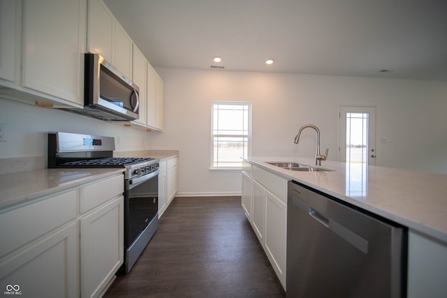 kitchen featuring white cabinetry, appliances with stainless steel finishes, dark wood-type flooring, and sink