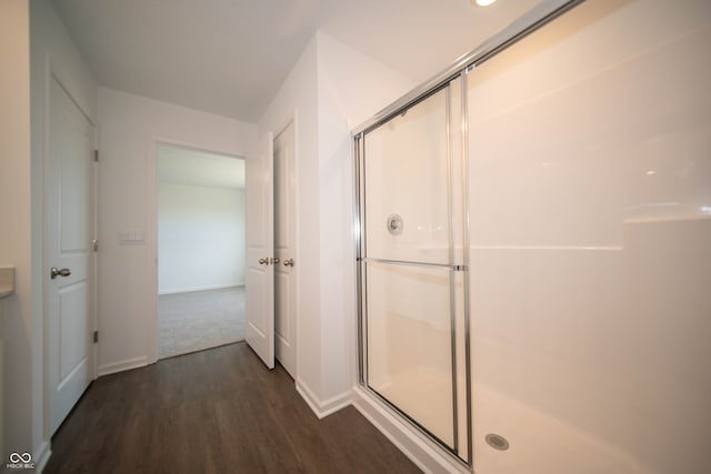 bathroom featuring hardwood / wood-style floors and an enclosed shower