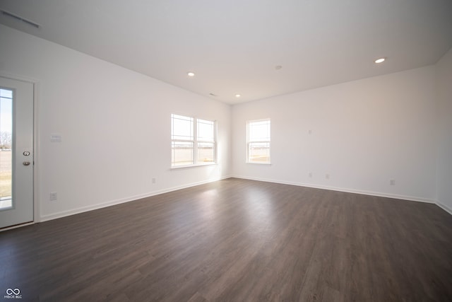 spare room featuring dark wood-type flooring