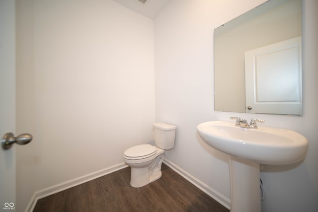 bathroom with wood-type flooring and toilet