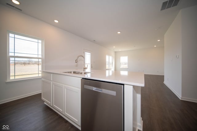 kitchen featuring dark hardwood / wood-style floors, sink, white cabinets, a kitchen island with sink, and stainless steel dishwasher