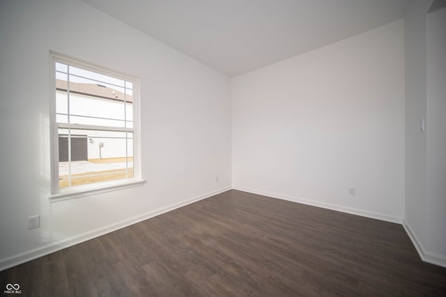 spare room featuring dark hardwood / wood-style flooring