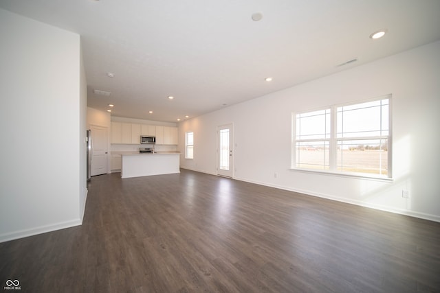 unfurnished living room featuring dark wood-type flooring