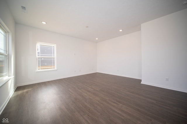 spare room featuring dark hardwood / wood-style flooring