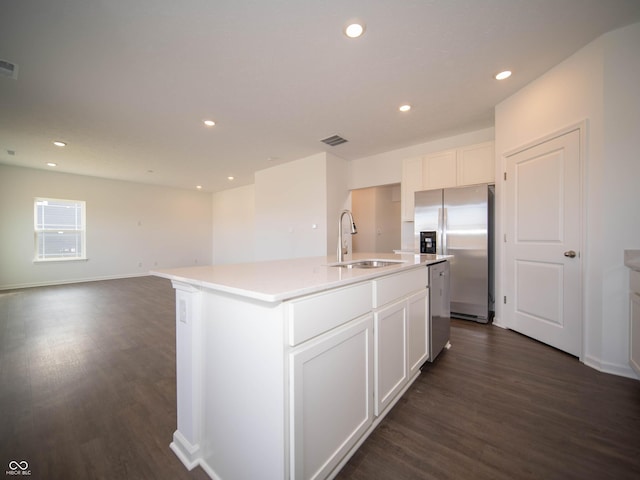 7872 Magnolia St, New Palestine, IN 46163 - kitchen with stainless steel appliances, dark wood-style flooring, a kitchen island with sink, white cabinets, and recessed lighting