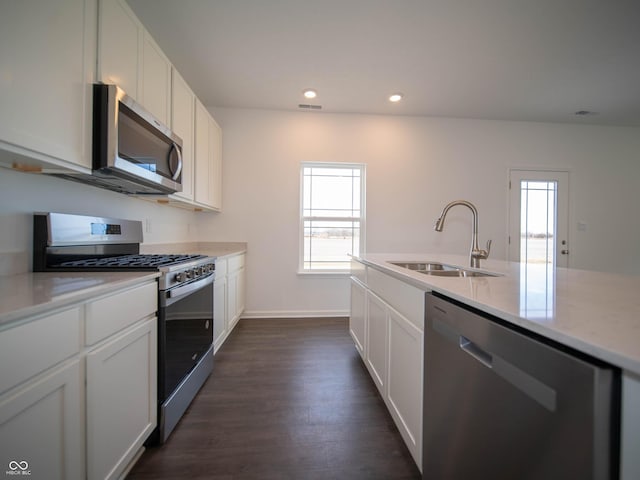 7872 Magnolia St, New Palestine, IN 46163 - kitchen featuring appliances with stainless steel finishes, white cabinetry, dark wood finished floors, recessed lighting, and light stone countertops