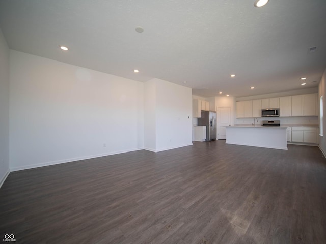 7872 Magnolia St, New Palestine, IN 46163 - unfurnished living room with dark wood finished floors and recessed lighting