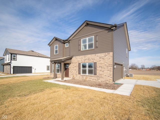 7872 Magnolia St, New Palestine, IN 46163 - view of front of house with an attached garage, brick siding, concrete driveway, and a front yard