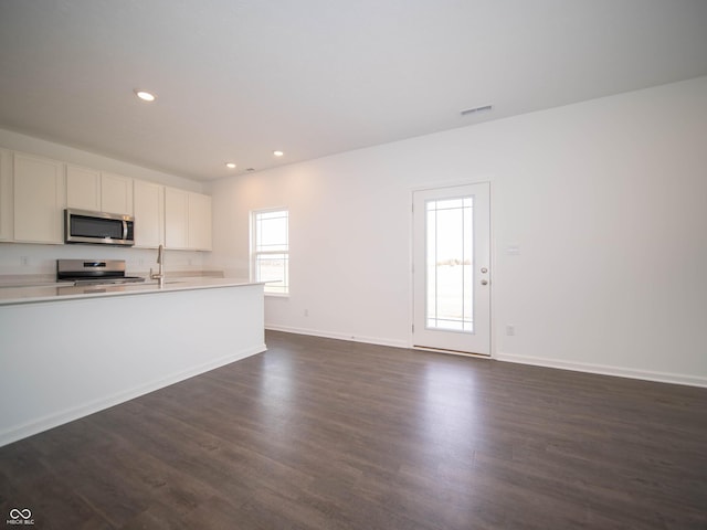 7872 Magnolia St, New Palestine, IN 46163 - kitchen featuring appliances with stainless steel finishes, light countertops, dark wood-type flooring, recessed lighting, and open floor plan