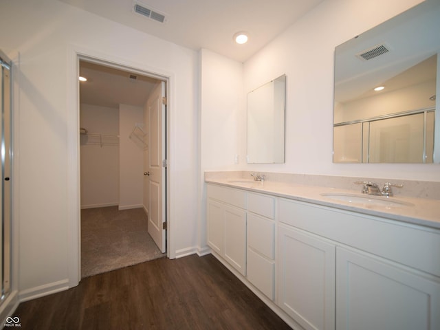 7872 Magnolia St, New Palestine, IN 46163 - full bathroom featuring a stall shower, wood finished floors, double vanity, and a spacious closet