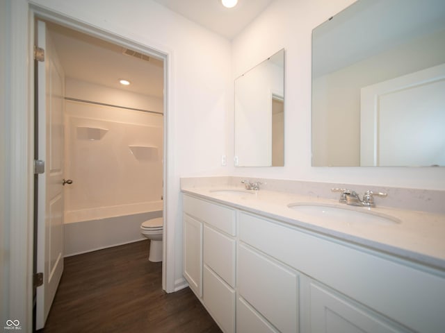 7872 Magnolia St, New Palestine, IN 46163 - full bathroom with double vanity, wood finished floors, shower / bathtub combination, and recessed lighting