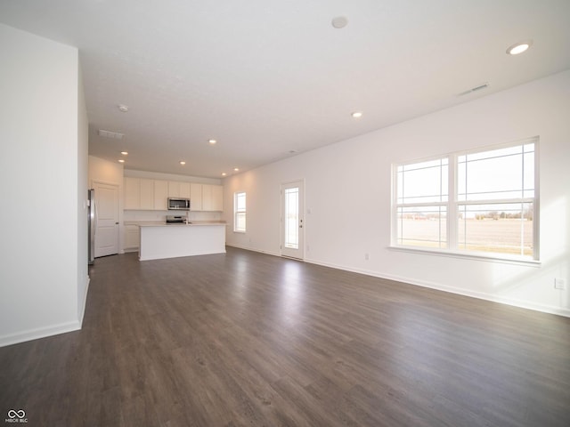 7872 Magnolia St, New Palestine, IN 46163 - unfurnished living room with recessed lighting and dark wood-type flooring