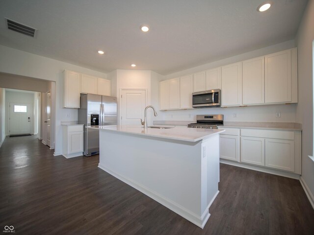 7872 Magnolia St, New Palestine, IN 46163 - kitchen featuring appliances with stainless steel finishes, white cabinets, dark wood-type flooring, and recessed lighting