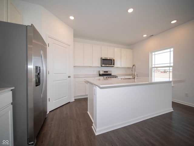 7872 Magnolia St, New Palestine, IN 46163 - kitchen featuring appliances with stainless steel finishes, dark wood-style flooring, light countertops, white cabinets, and recessed lighting
