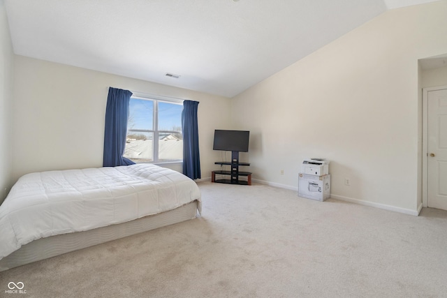 bedroom featuring vaulted ceiling and carpet floors