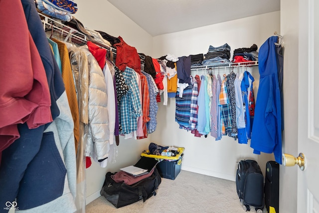 spacious closet featuring light colored carpet