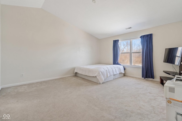 carpeted bedroom with lofted ceiling