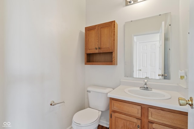 bathroom with toilet and vanity