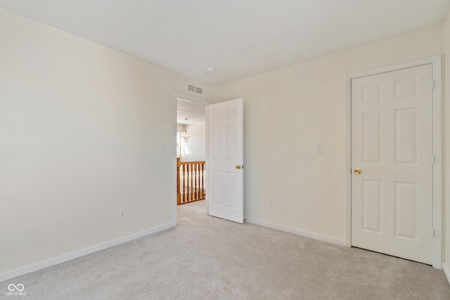 unfurnished bedroom featuring light carpet