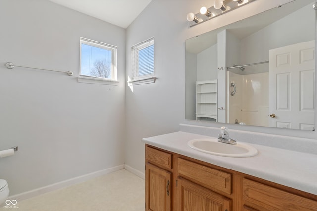 bathroom with toilet, walk in shower, lofted ceiling, and vanity