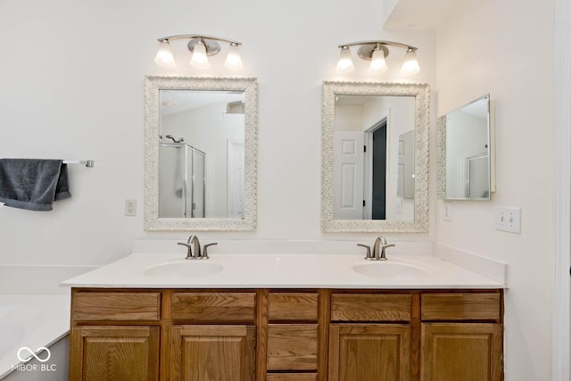 bathroom featuring a shower with shower door and vanity