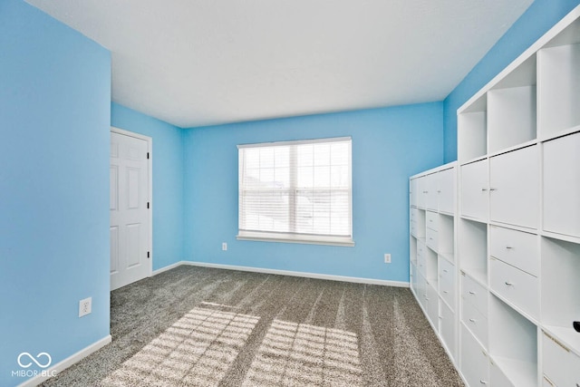 unfurnished bedroom featuring dark carpet