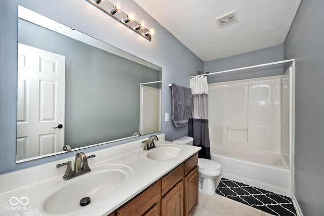 full bathroom with shower / bath combo with shower curtain, a textured ceiling, toilet, and vanity