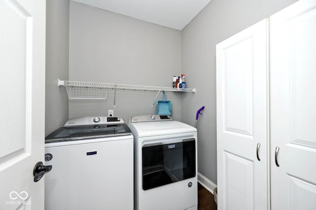 laundry room featuring dark hardwood / wood-style floors and separate washer and dryer