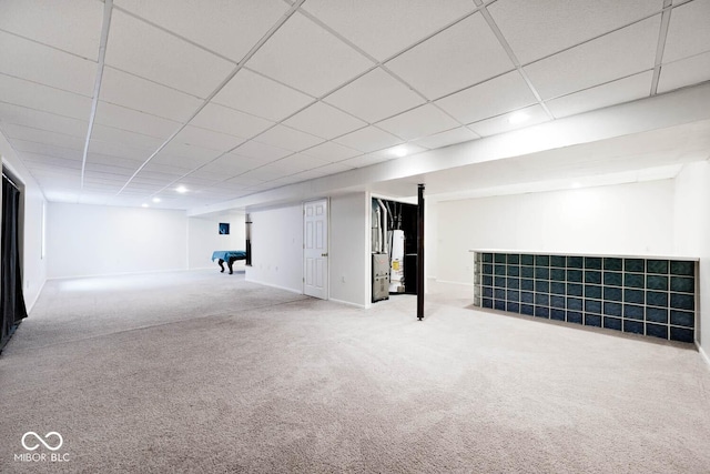 basement featuring carpet floors and a paneled ceiling