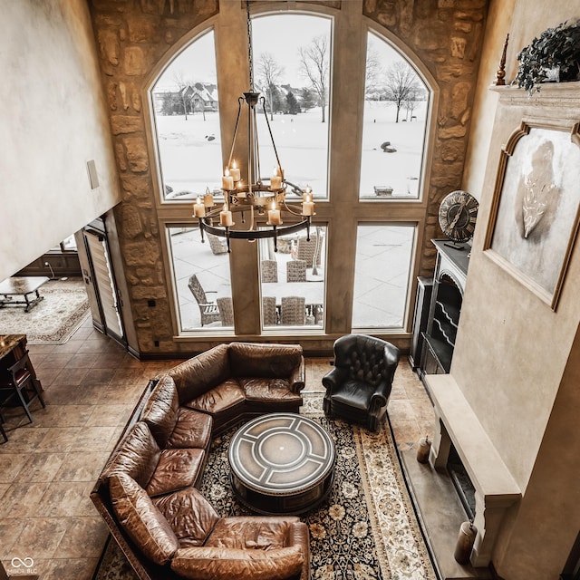 living area featuring an inviting chandelier and a towering ceiling