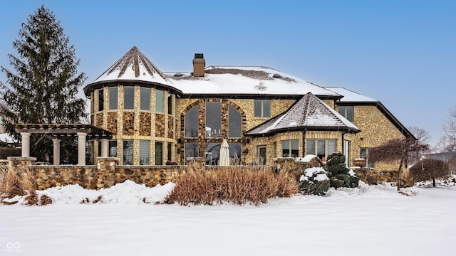 view of snow covered rear of property