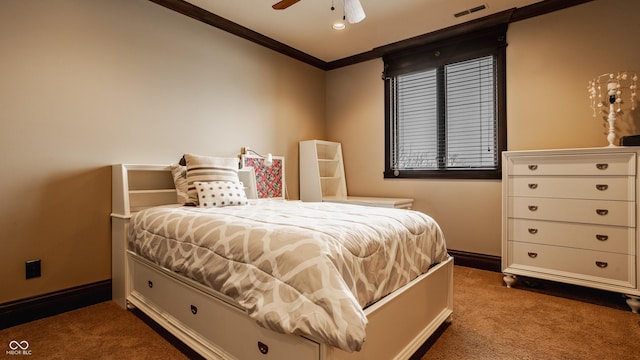 carpeted bedroom with ceiling fan and ornamental molding