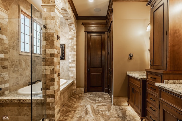 bathroom with vanity, ornamental molding, and tiled tub