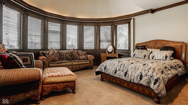 carpeted bedroom featuring vaulted ceiling, ornamental molding, and multiple windows