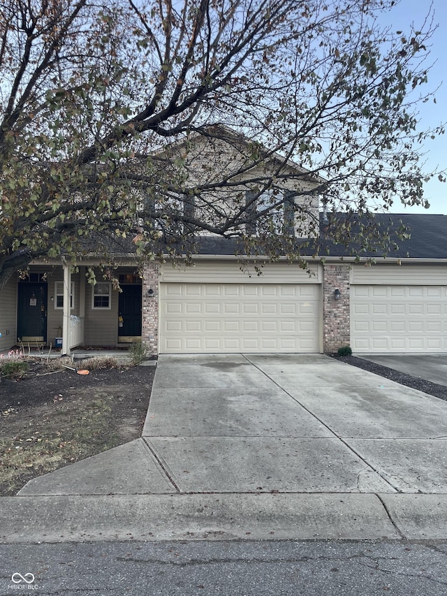 7218 Forrester Ln, Indianapolis, IN 46217 - view of front facade with concrete driveway, brick siding, and an attached garage