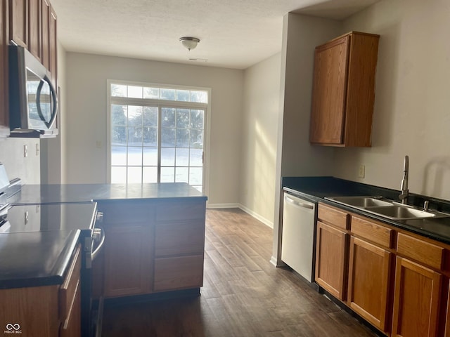 kitchen featuring sink, dark hardwood / wood-style floors, and appliances with stainless steel finishes