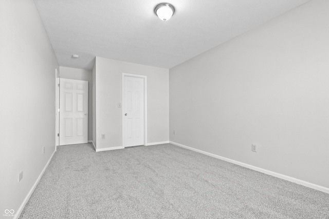 unfurnished bedroom with carpet floors and baseboards