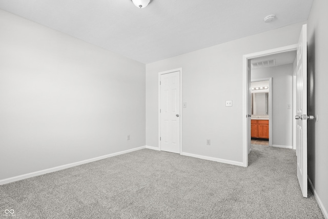 unfurnished bedroom with carpet flooring, visible vents, and baseboards