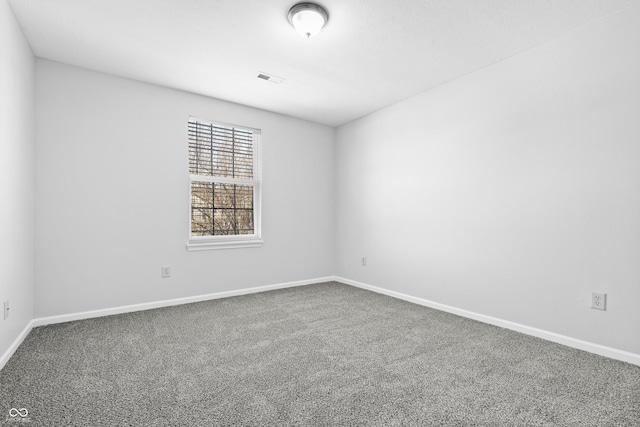 carpeted empty room with baseboards