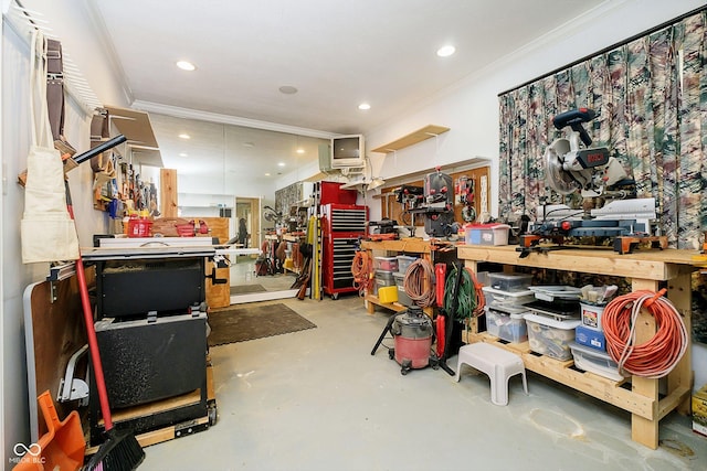 misc room with concrete flooring, crown molding, and a workshop area