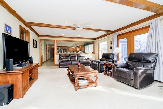 living room with beamed ceiling, ceiling fan, ornamental molding, and carpet floors