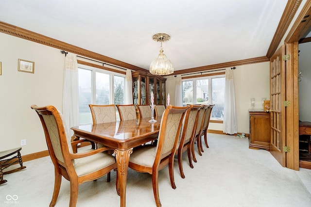 carpeted dining room with a notable chandelier and crown molding