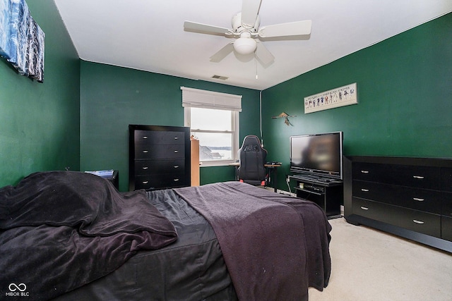 bedroom featuring light carpet and ceiling fan