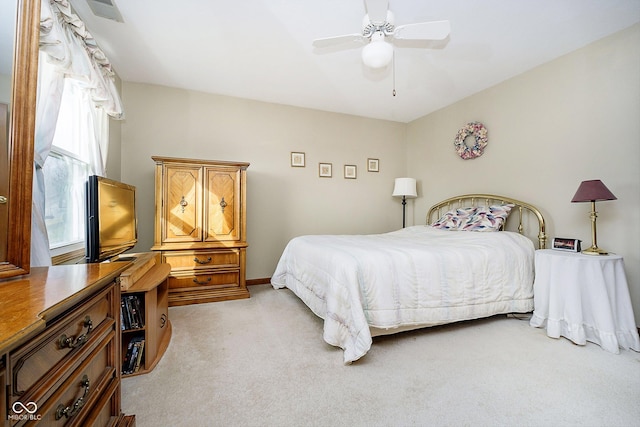 bedroom featuring light carpet and ceiling fan