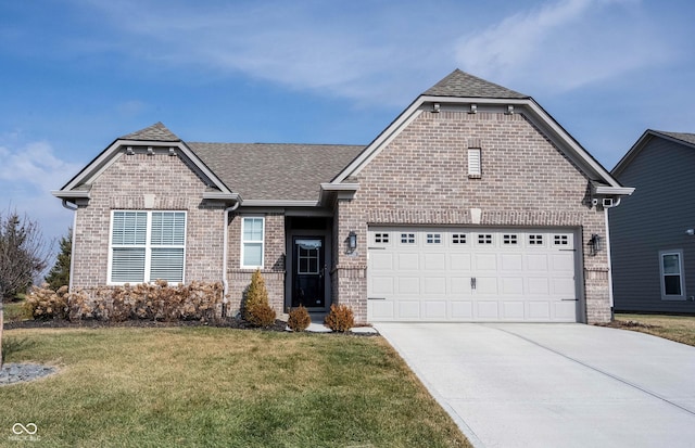 view of front of house featuring a garage and a front lawn