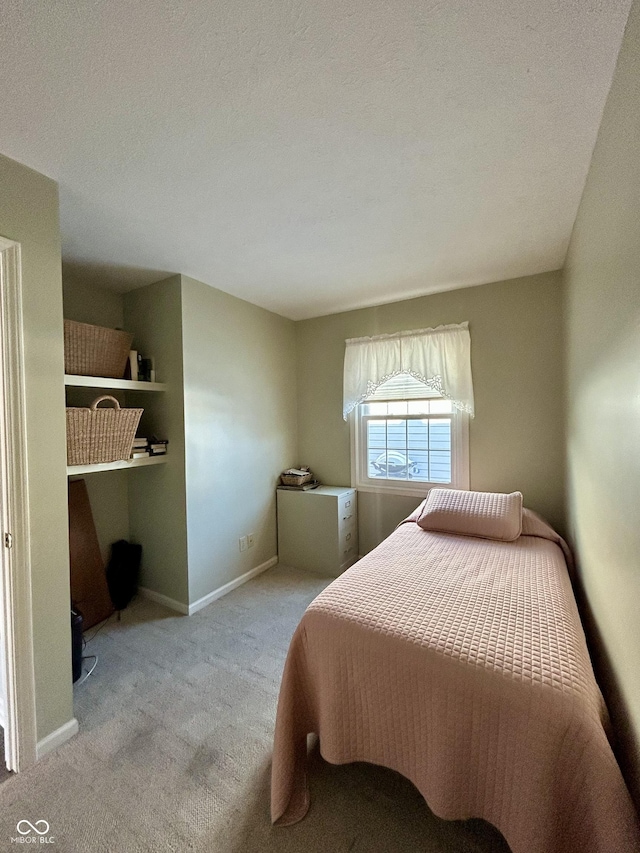 carpeted bedroom with a textured ceiling