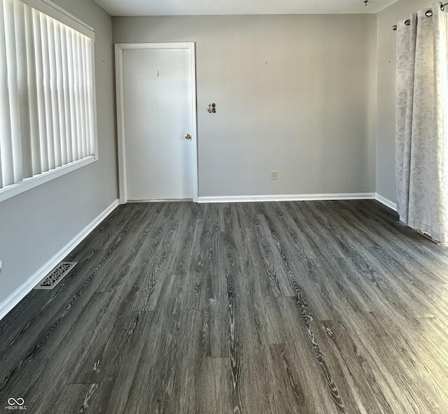 unfurnished room featuring dark hardwood / wood-style flooring