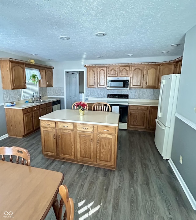 kitchen featuring a center island, stainless steel appliances, and dark hardwood / wood-style floors